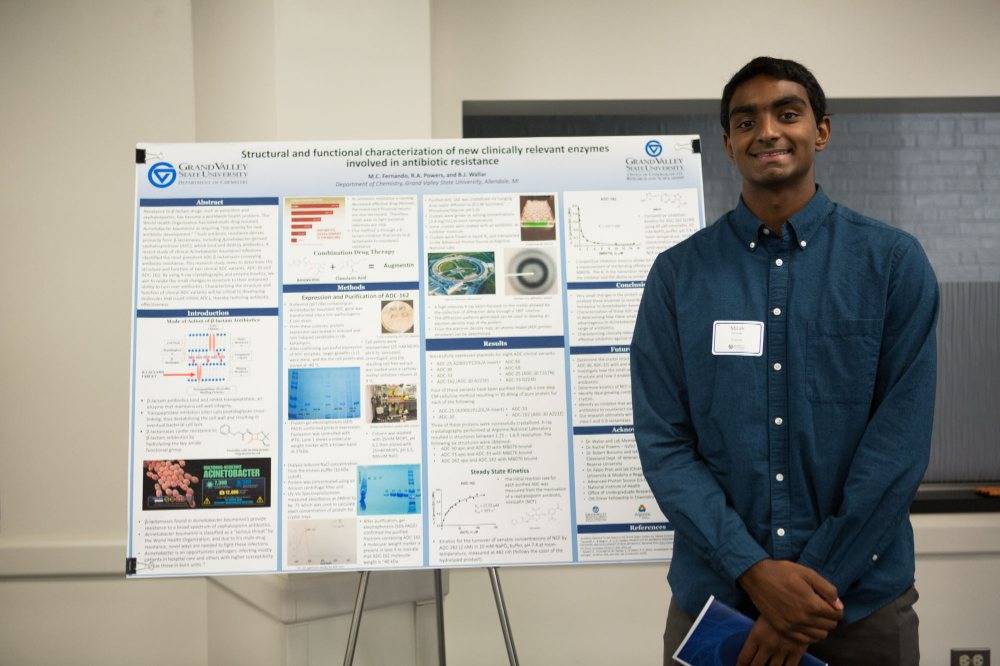 Micah Fernando pictured with research presentation during Student Scholars Day